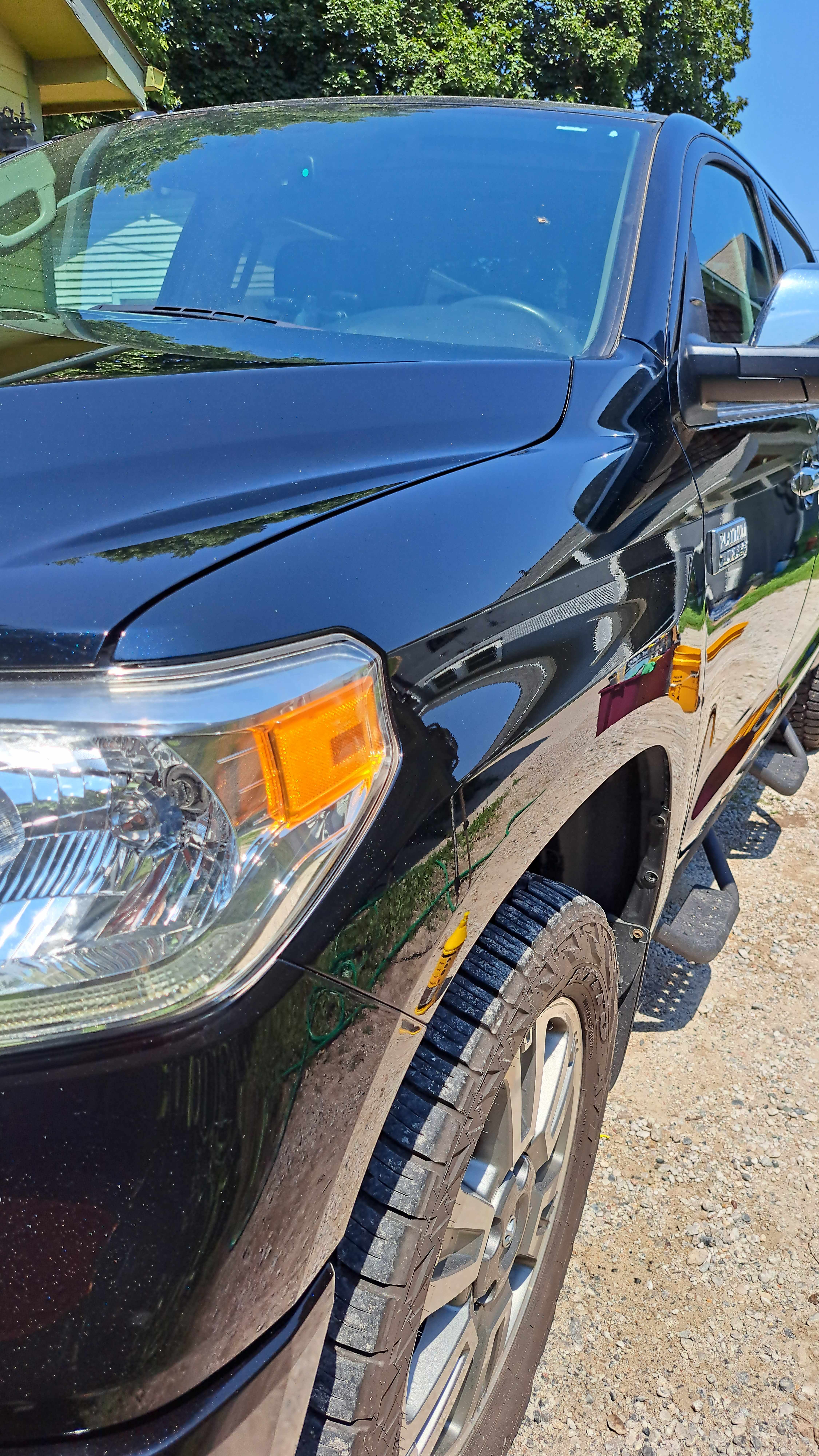 Freshly corrected black Toyota Tundra with a deep mirror finish
